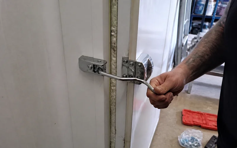 Cam-lock wall panel joint showing the insulated core and vapor barrier