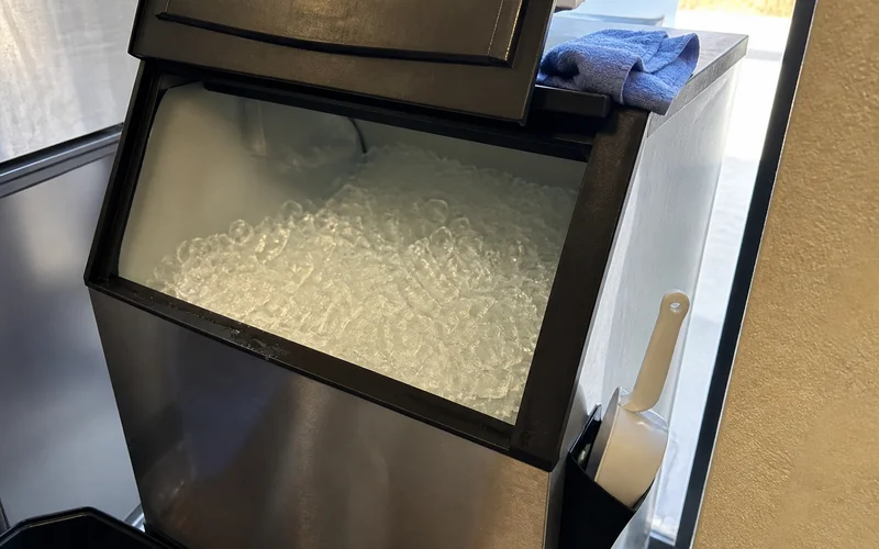 Clean, sanitized commercial ice machine bin ready for service