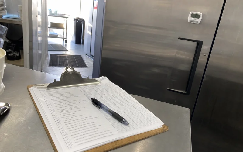 Completed refrigeration maintenance checklist and temperature log