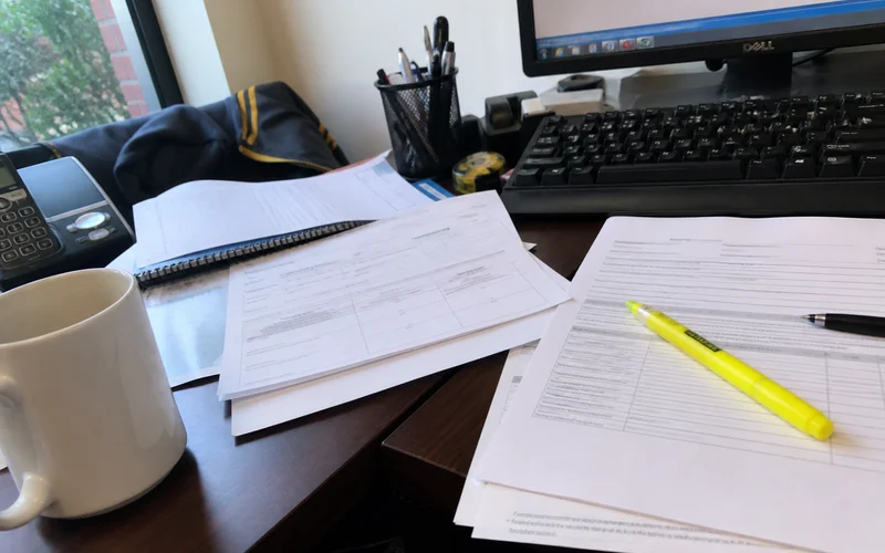 Equipment purchase invoice and warranty documents on a restaurant office desk