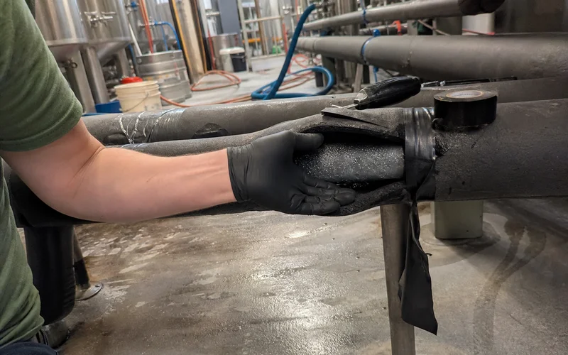 Insulated glycol lines being inspected for leaks and damaged insulation