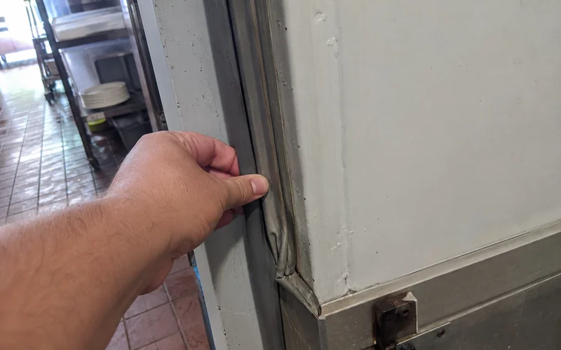 Worn walk-in cooler door gasket letting warm air into the cold room