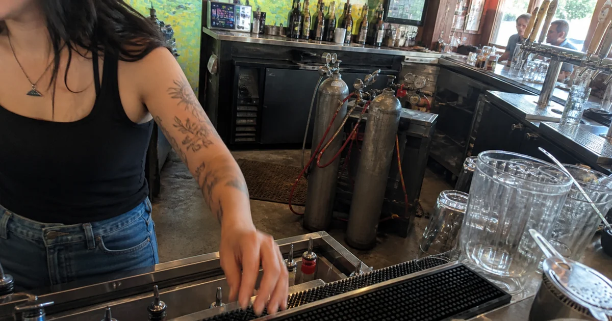 CO2 cylinders staged behind a busy Portland bar near the soda and draft system