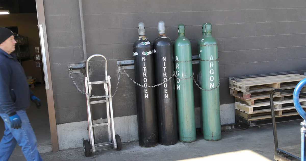 High-pressure nitrogen and argon cylinders secured in a commercial gas storage area
