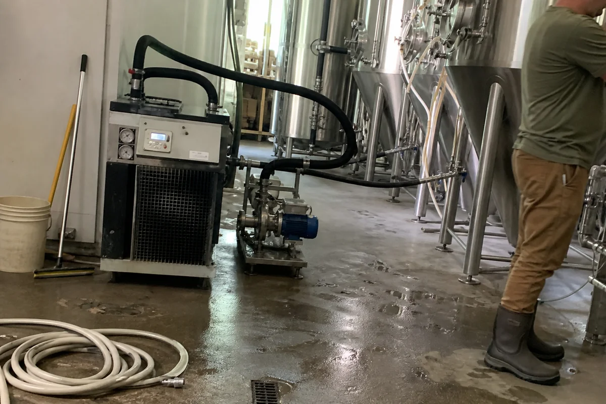 Glycol chiller and pump connected to fermentation tanks in a Portland brewery