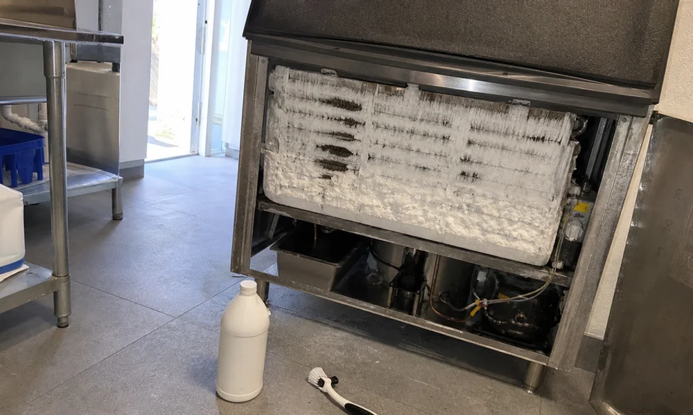 Scale deposits on a nickel-plated ice machine evaporator grid before descaling