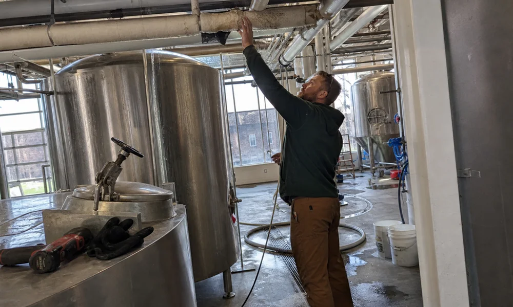 Insulated glycol lines running to brewery serving tanks during a leak inspection
