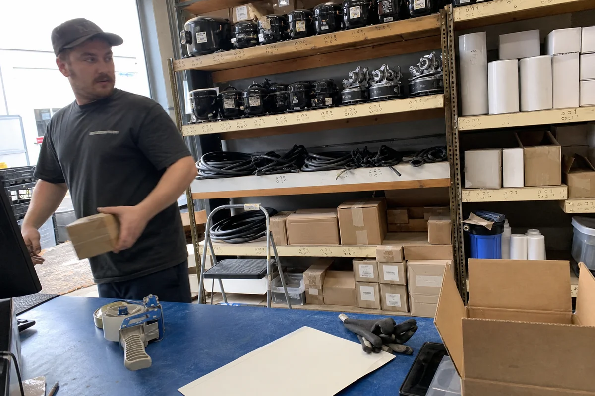 Parts counter shelving stocked with commercial refrigeration components and water filters in Portland